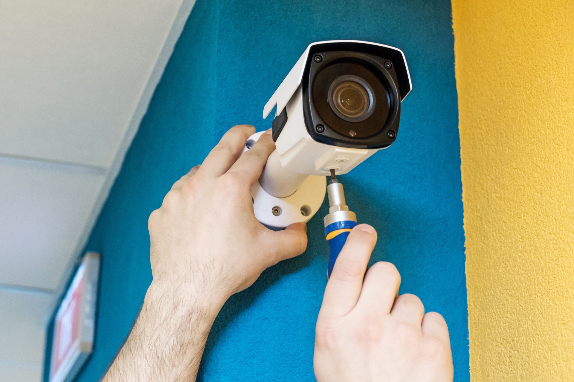 Technician worker installing video surveillance camera. CCTV camera closeup